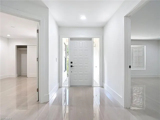Foyer entrance featuring light tile patterned flooring and recessed lighting