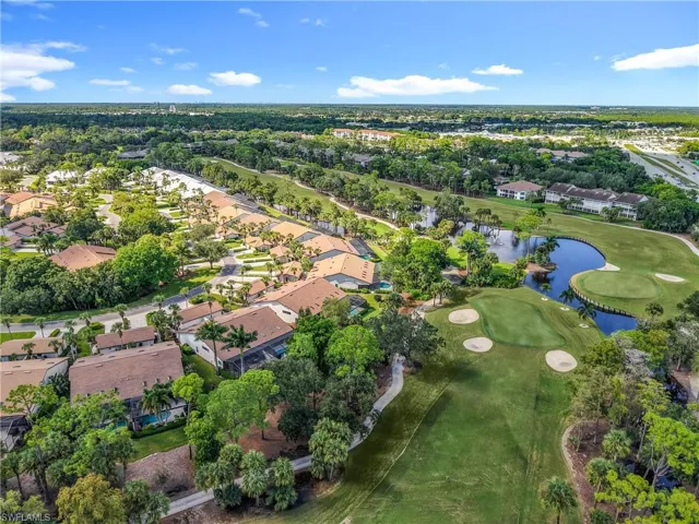 Aerial overview of property's location with a nearby body of water, nearby suburban area, and a golf course