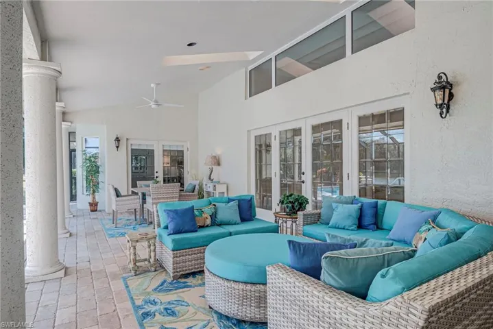 View of patio / terrace with french doors, ceiling fan, and an outdoor living / dining area
