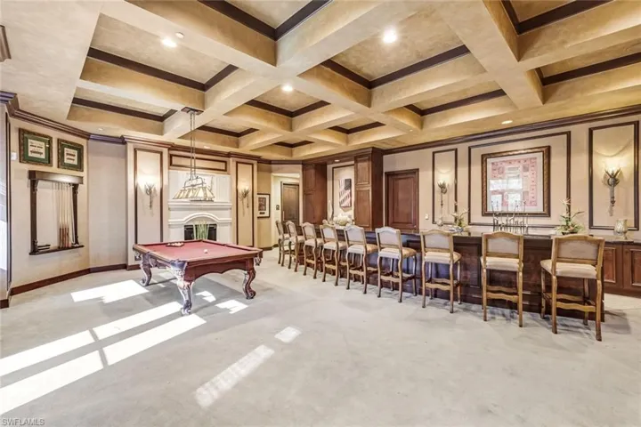 Game room with billiards table, coffered ceiling, recessed lighting, a decorative wall, and ornamental molding