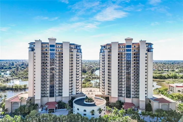 View of apartment building / complex featuring a water view