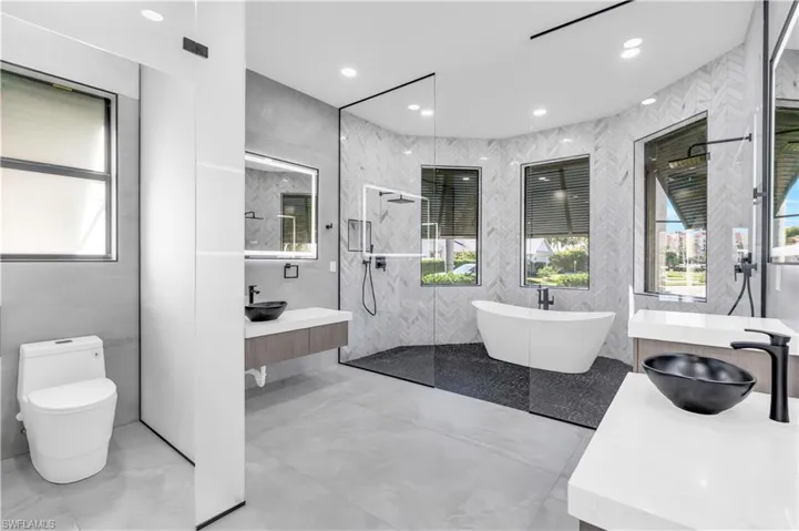 Full bathroom featuring plenty of natural light and a shower stall