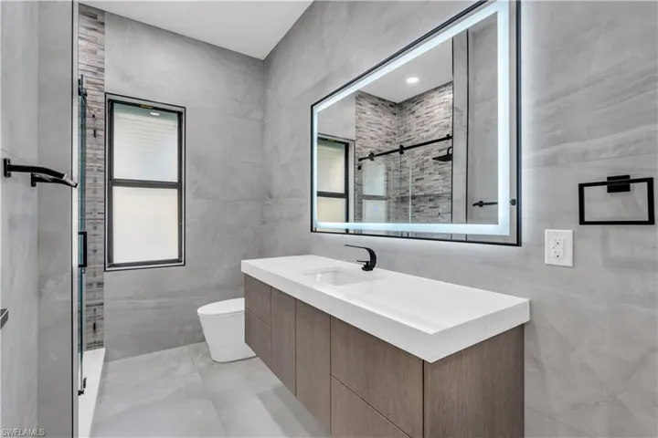 Bedroom with access to outside, recessed lighting, a tray ceiling, and ceiling fan