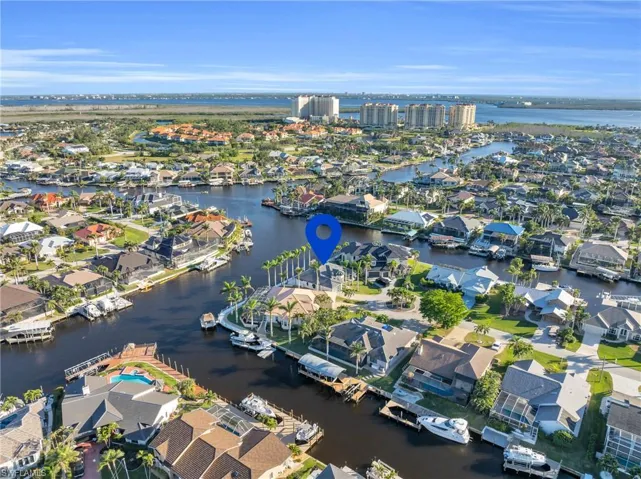 Aerial perspective of suburban area featuring a large body of water