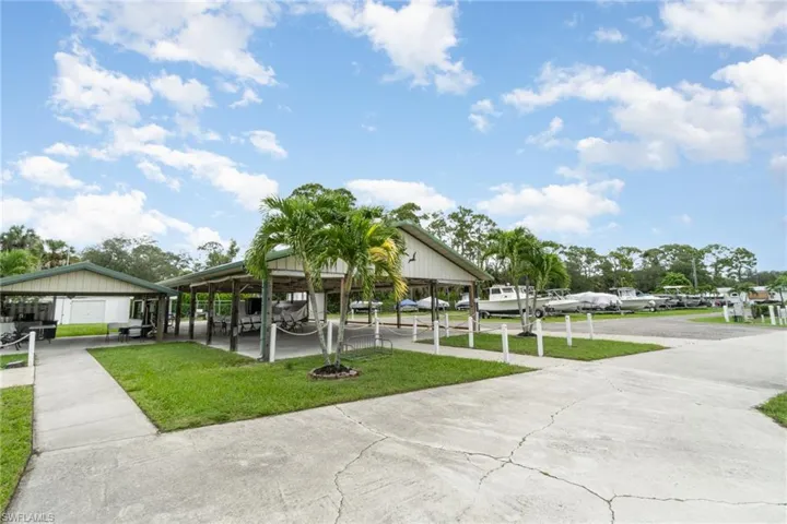 Dock area featuring a water view, a yard, and view of scattered trees