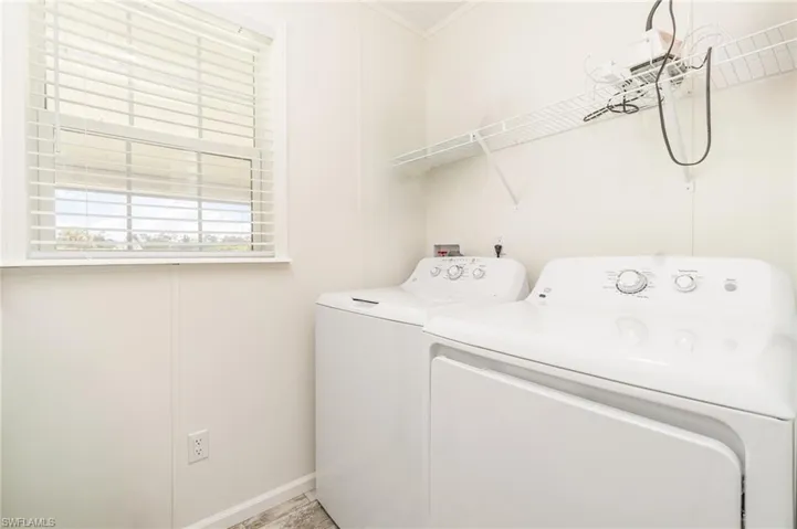 Guest/Halll bathroom featuring light wood-style flooring, shower / bath combination with curtain, vanity, and crown molding