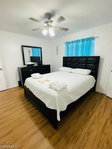 Bedroom featuring wood finished floors and ceiling fan