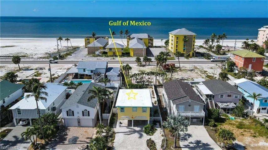 Aerial view prior to Hurricane Helene with a view of the beach and a water view