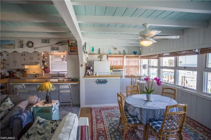 Dining area prior to Hurricane Helene featuring ceiling fan, hardwood / wood-style flooring, and beamed ceiling