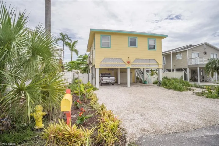 View of Front Raised beach house  prior to Hurricane Helene with a 2 car carport