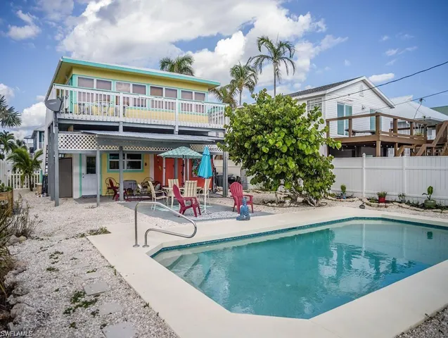 View of swimming pool prior to Hurricane Helene with a patio and a deck