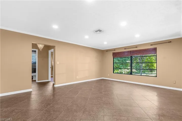 Empty room featuring ornamental molding and recessed lighting