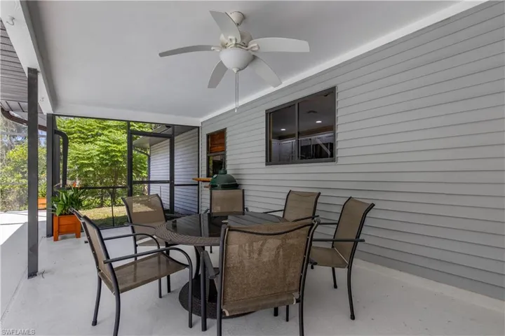 Sunroom featuring ceiling fan and outdoor dining space