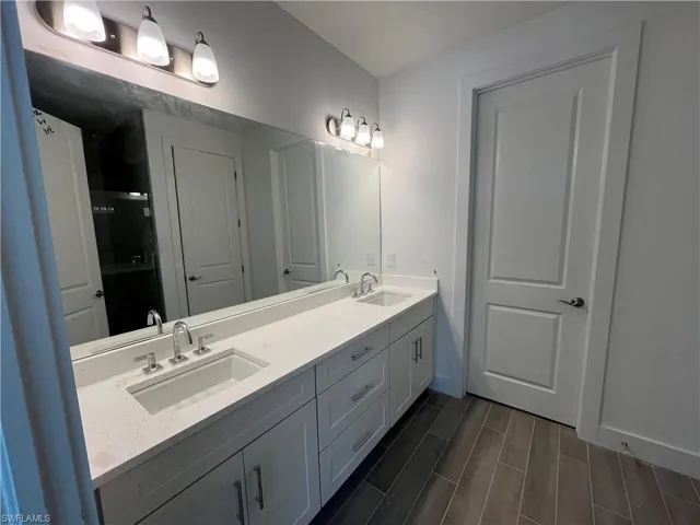 Primary bathroom with dual-sinks, quartz countertops, and soft-close cabinets and drawers
