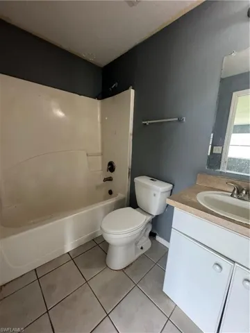 Full bathroom with tile patterned flooring, vanity, and shower / bathtub combination