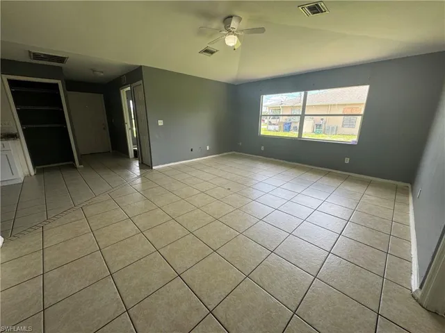 Unfurnished room with a ceiling fan and light tile patterned floors