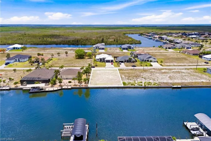 Waterfront vacant lot featuring a cleared building site and direct canal access