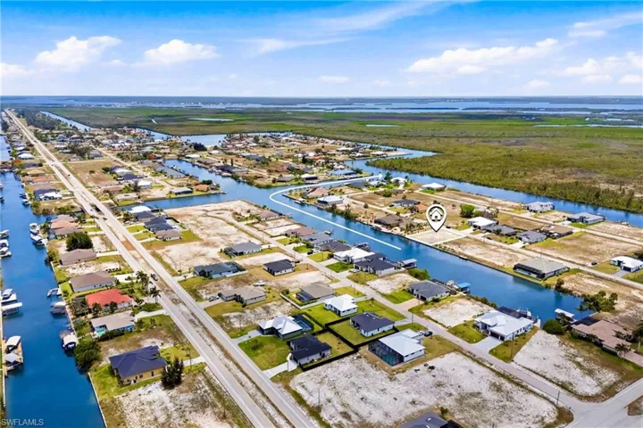Aerial panorama featuring multiple waterfront properties with direct canal access