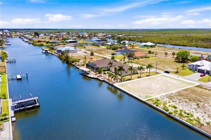 Waterfront lot with canal frontage, featuring a clear, level building area