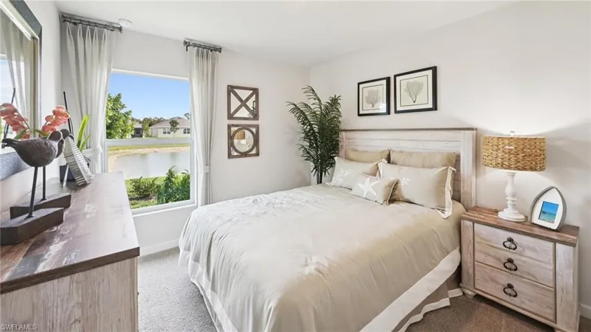 Model Home. This room features a window providing views of a body of water and surrounding properties