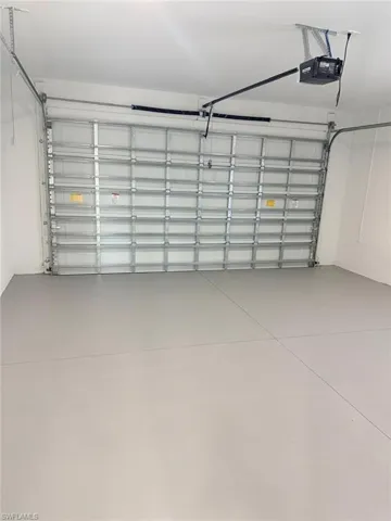 Garage featuring a garage door opener