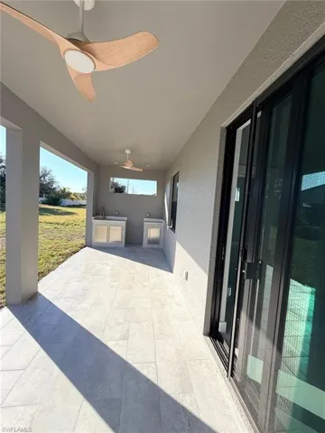 View of patio with ceiling fan and exterior kitchen