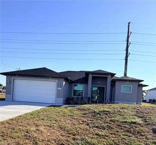 View of front of property featuring stucco siding, a shingled roof, driveway, a garage, and a front lawn