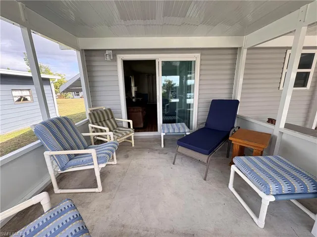 Sunroom featuring a patio area