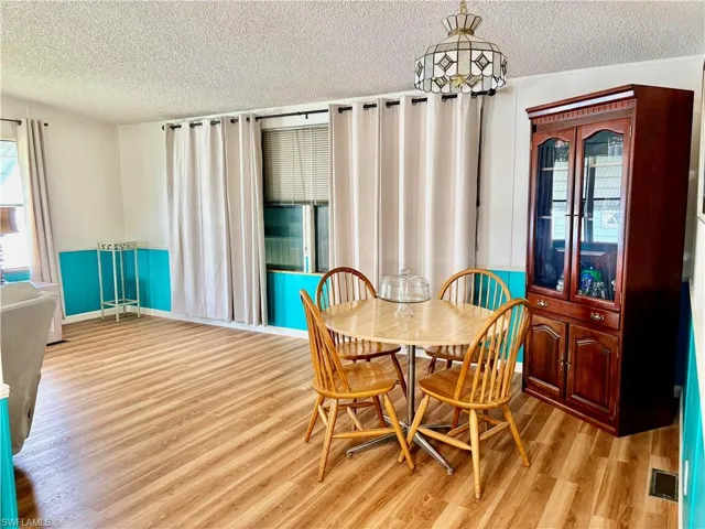 Dining room featuring a textured ceiling and light wood-type flooring