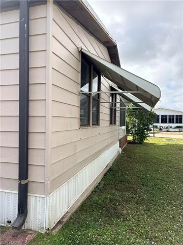 View of home's exterior with a yard