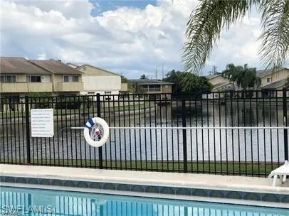 Community pool with a residential view