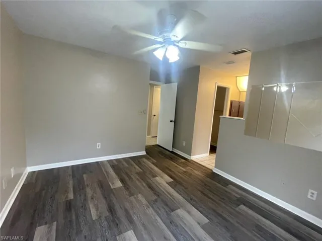 Spare room with dark hardwood / wood-style floors and ceiling fan