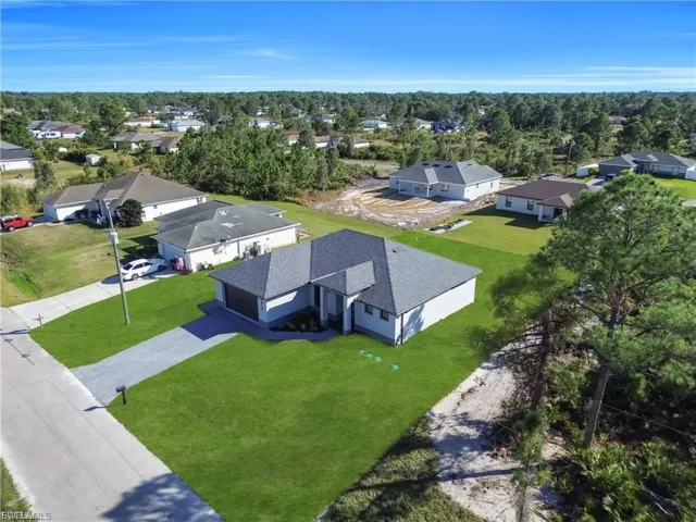 Aerial perspective of suburban area featuring a tree filled landscape