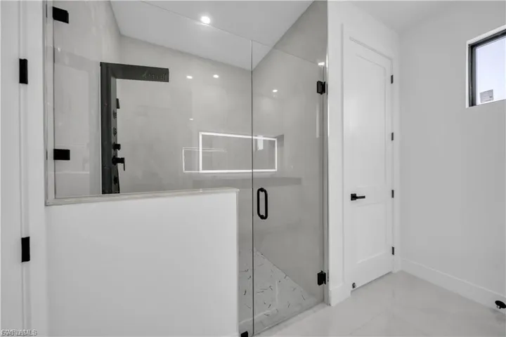Full bathroom featuring a stall shower and recessed lighting