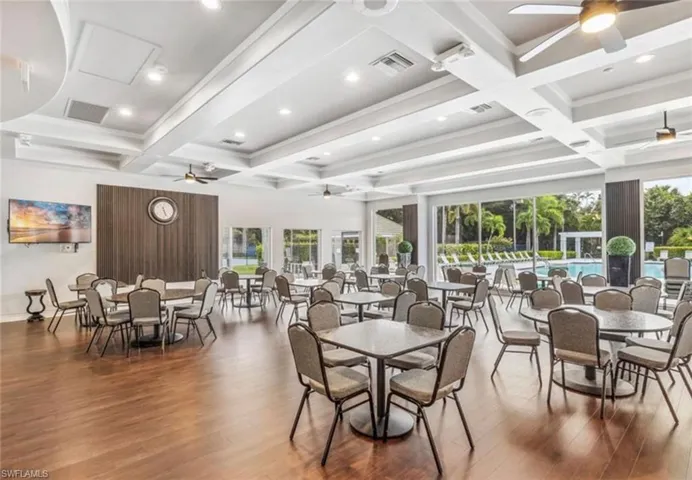 Dining area featuring a ceiling fan, beamed ceiling, coffered ceiling, hardwood / wood-style floors, and recessed lighting