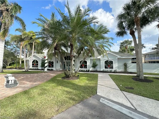 View of front of house featuring a front lawn and stucco siding