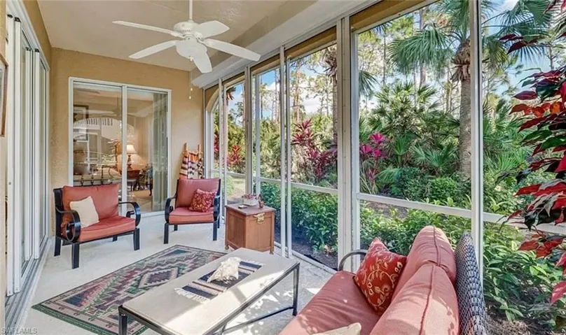 Sunroom / solarium featuring a ceiling fan, carpet floors, and an outdoor hangout area