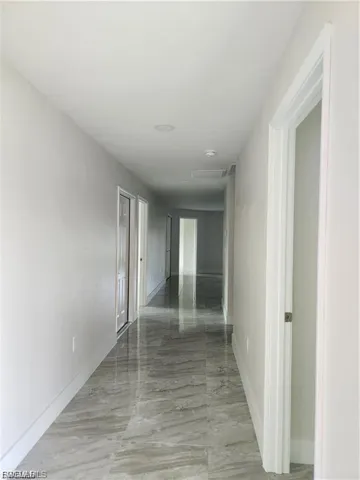 Hall with attic access and baseboards