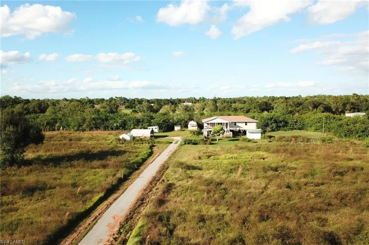 Aerial view of sparsely populated area featuring a heavily wooded area