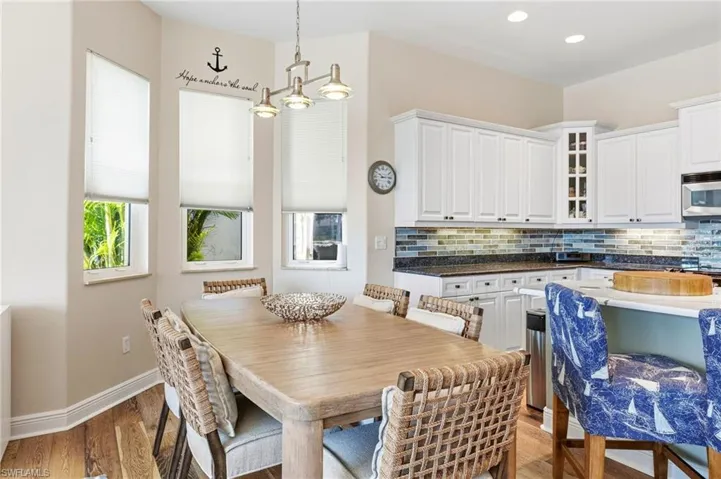 A cozy dining nook provides a warm and inviting space for everyday meals, morning coffee, or intimate gatherings.
