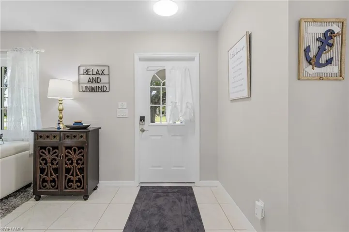 Tiled foyer with a healthy amount of sunlight
