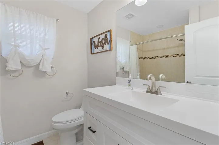 Bathroom featuring vanity and toilet
