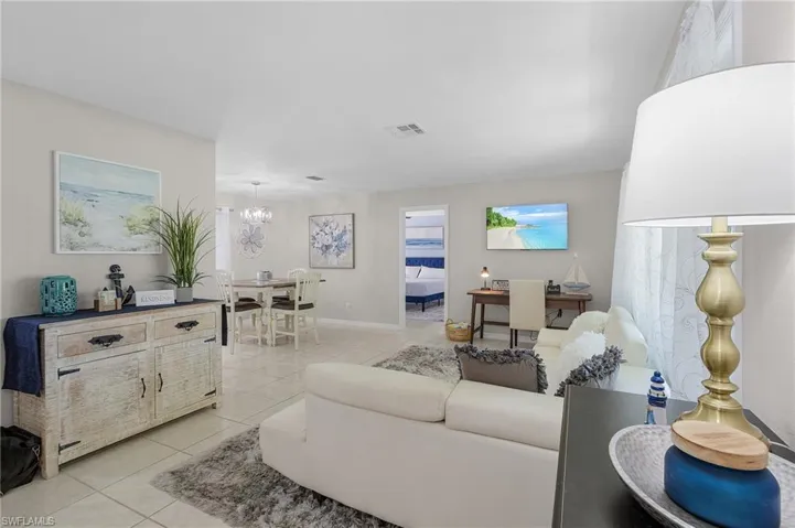 Tiled living room with a chandelier