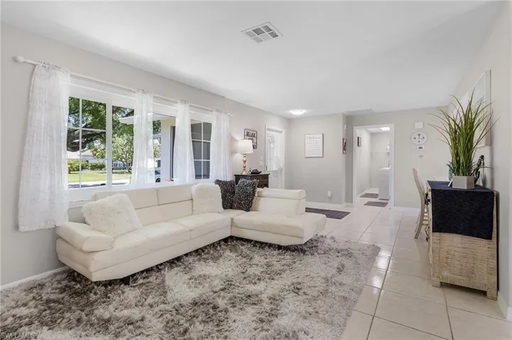 Living room featuring light tile floors