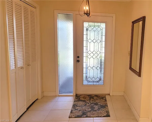 Entrance foyer featuring light tile patterned flooring