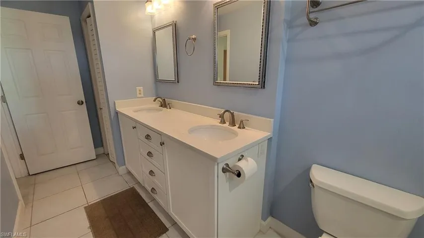 Bathroom featuring tile patterned floors, toilet, and vanity