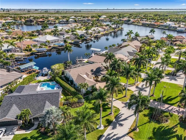 Aerial view of property's location with nearby suburban area and a nearby body of water