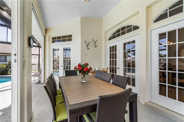 Dining room featuring french doors and a textured wall