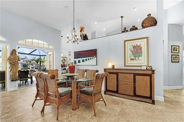 Dining space featuring high vaulted ceiling and a chandelier