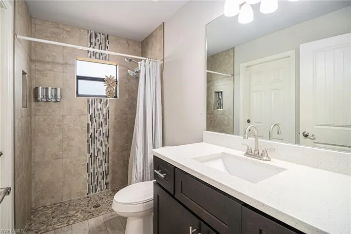 Full bath with vanity and a shower stall